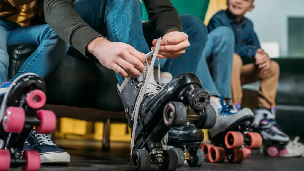 Skaters lacing up roller skates